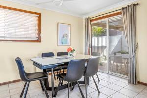 a dining room with a table and chairs at Coastal Delight In Shellcove in Dunmore