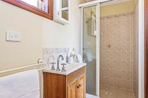 a bathroom with a sink and a shower at Coastal Delight In Shellcove in Dunmore