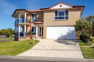 a large brick house with a garage at Coastal Delight In Shellcove in Dunmore