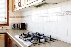 a kitchen with a stove top oven in a kitchen at Coastal Delight In Shellcove in Dunmore