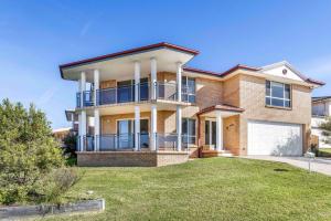 a large brick house with a yard at Coastal Delight In Shellcove in Dunmore