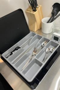 a tray with silver utensils sitting on a counter at 103新大阪15分,下新庄8分の静かで快適な貸切1ルーム in Osaka