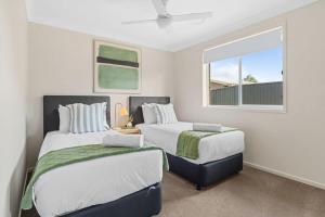 a bedroom with two beds and a window at Vineyard Oasis Heart of the Hunter in Cessnock +37 photos