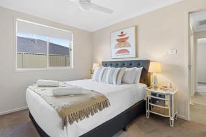 a bedroom with a large bed and a window at Vineyard Oasis Heart of the Hunter in Cessnock +31 photos