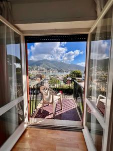 a balcony with a chair and a view of a city at Eurotel 406 in Rapallo