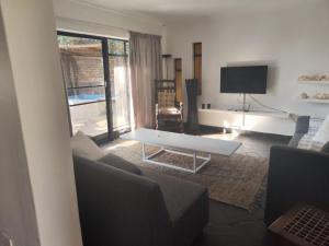a living room with a couch and a table at Escape in Pretoria