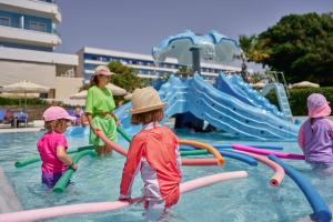 a group of children playing in a water park at Blue Sea Beach Resort in Faliraki
