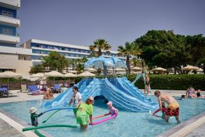 a group of people playing in the water at a pool at Blue Sea Beach Resort in Faliraki