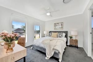 a bedroom with a bed and a large window at Cessnock Haven Contemporary Country Retreat in Cessnock +30 photos