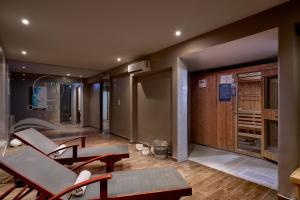 a room with chairs and a table and a door at Blue Sea Beach Resort in Faliraki