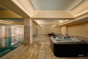 a large room with a hot tub in the middle at Blue Sea Beach Resort in Faliraki