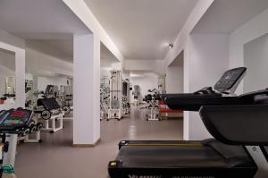 a gym with several treadmills and machines at Blue Sea Beach Resort in Faliraki