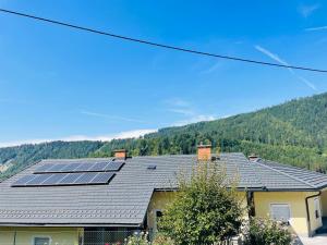 a house with solar panels on the roof at Haus LINDE Görtschitztal in Sankt Veit an der Glan