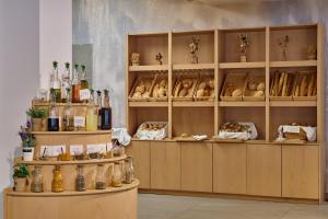 a room with shelves filled with bottles and food at Blue Sea Beach Resort in Faliraki