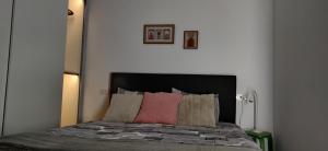 a bed with a black headboard and two pillows at Modern Apartment with great terasse and mountain view in Braşov