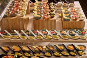 a buffet line with many plates of food at Blue Sea Beach Resort in Faliraki