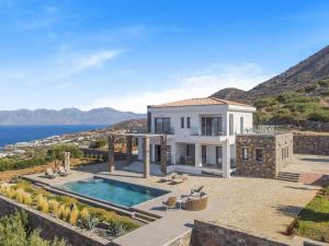 a villa with a swimming pool on a hill at Sole Mare Luxury Villa With Sea View & Private Pool in Elounda in Elounda