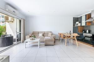 a living room with a couch and a table at Benalmádena Puerto Marina Vacation Apartment 1 minute from the beach in Benalmadena Costa