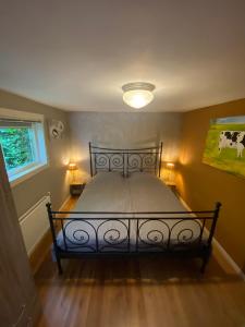 a bedroom with a bed in a room with a cow painting at La Luna - Denise in Heerhugowaard +12 photos