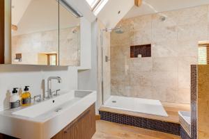 a bathroom with a sink and a shower at Hilltop View with Hot Tub in Brecon +65 photos