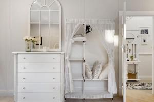 a bedroom with a white dresser and a closet at Janie s Cottage Secluded Wine Country Home in Broke +32 photos