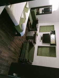 an overhead view of a living room with green furniture at Hotel Kular at Saket Near PVR Cinema in New Delhi