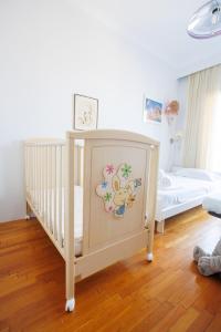 a nursery with a crib with a monkey painted on it at Anastasia in Veria