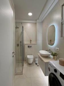 a bathroom with a shower and a toilet and a sink at DMM Apartments in Tivat +59 photos