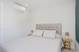 a white bedroom with a white bed with white pillows at Apartamento Brisa Marina in Arona +88 photos