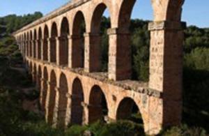 a stone bridge with arches on the side of it at Plaça De La Font in Tarragona