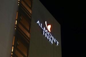 a neon sign on the side of a building at Almont Inn Shonan Fujisawa in Fujisawa +32 photos