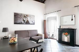a living room with a table and a couch at Loft Iglesias in Iglesias