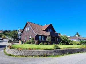 a brown house with a brown roof at Comfortable house with balcony&Terrace and view in Kopervik