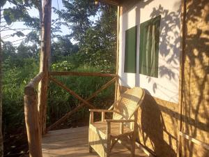 a chair sitting on the porch of a cabin at Kibale Tented Camp in Kibale Forest National Park