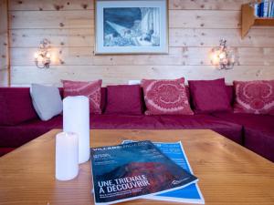una mesa con un libro encima de un sofá en Apartment Le Bristol A52 by Interhome, en Villars-sur-Ollon 28 fotos más