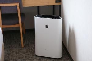 a small refrigerator sitting on the floor next to a table at Almont Inn Shonan Fujisawa in Fujisawa