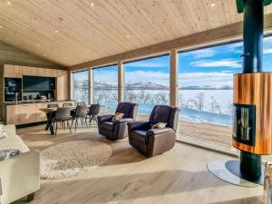 a living room with a view of the snow covered mountains at Holiday Home Loimu by Interhome in Kilpisjärvi