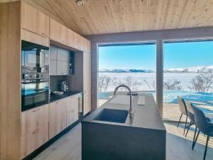 a kitchen with a sink and a large window at Holiday Home Loimu by Interhome in Kilpisjärvi