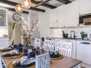 a kitchen with a table with blue and white dishes at Holiday Home Holiday pleikilä by Interhome in Kustavi
