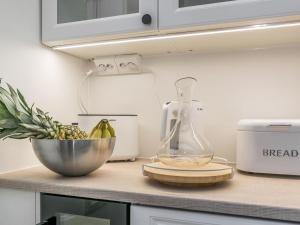 a kitchen counter with a blender and a bowl of bananas at Holiday Home Holiday pleikilä by Interhome in Kustavi