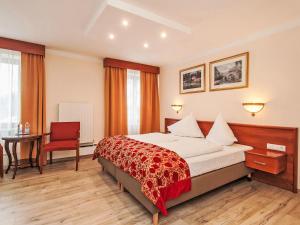 a hotel room with a large bed and a table at Holiday Home Gästehaus Beretta by Interhome in Achenkirch