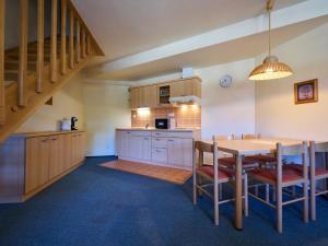 a kitchen with a table and a dining room at Apartment Harrachov 613-2 by Interhome in Harrachov
