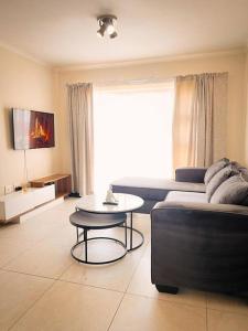 a living room with a couch and a table at Tetani's Luxury Oasis in Lakeside