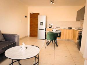 a kitchen and a living room with a table and a refrigerator at Tetani's Luxury Oasis in Lakeside