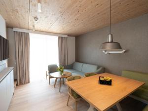 a living room with a table and a couch at Apartment Beech Resort Plauer See by Interhome in Ganzlin