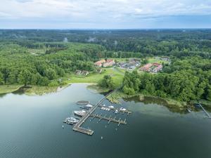 an aerial view of a dock with boats in the water at Apartment Beech Resort Plauer See by Interhome in Ganzlin