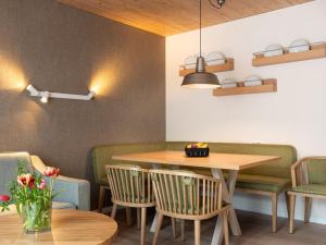 a dining room with a table and chairs at Apartment Beech Resort Plauer See by Interhome in Ganzlin