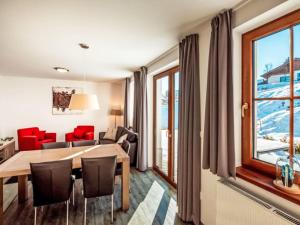 a living room with a table and chairs and a window at Holiday Home Residence Lipno-9 by Interhome in Lipno nad Vltavou