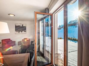 a room with a view of the ocean through a glass door at Holiday Home Residence Lipno-9 by Interhome in Lipno nad Vltavou
