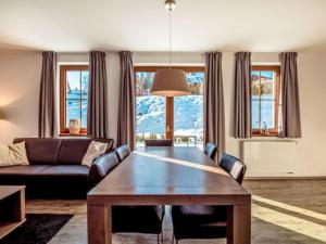a living room with a table and a couch at Holiday Home Residence Lipno-9 by Interhome in Lipno nad Vltavou +14 photos